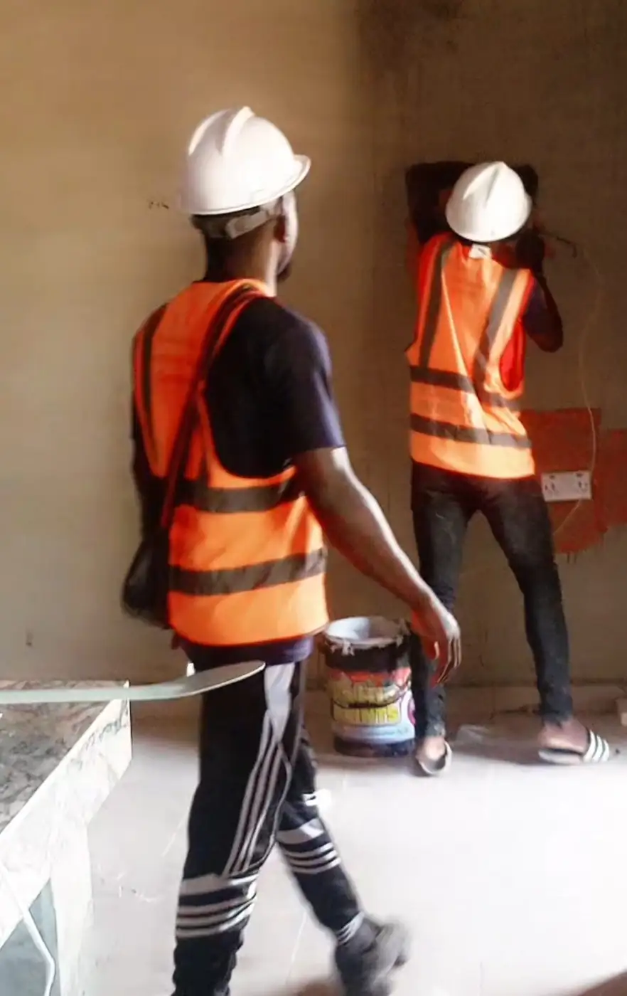 Site crew in hard hats and high-visibility vests