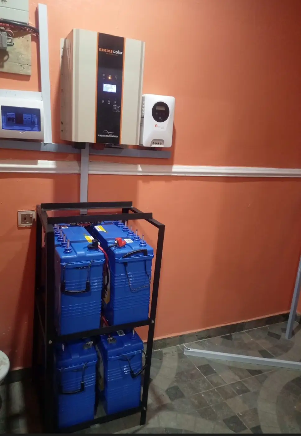Inverter and battery rack installed on a wall