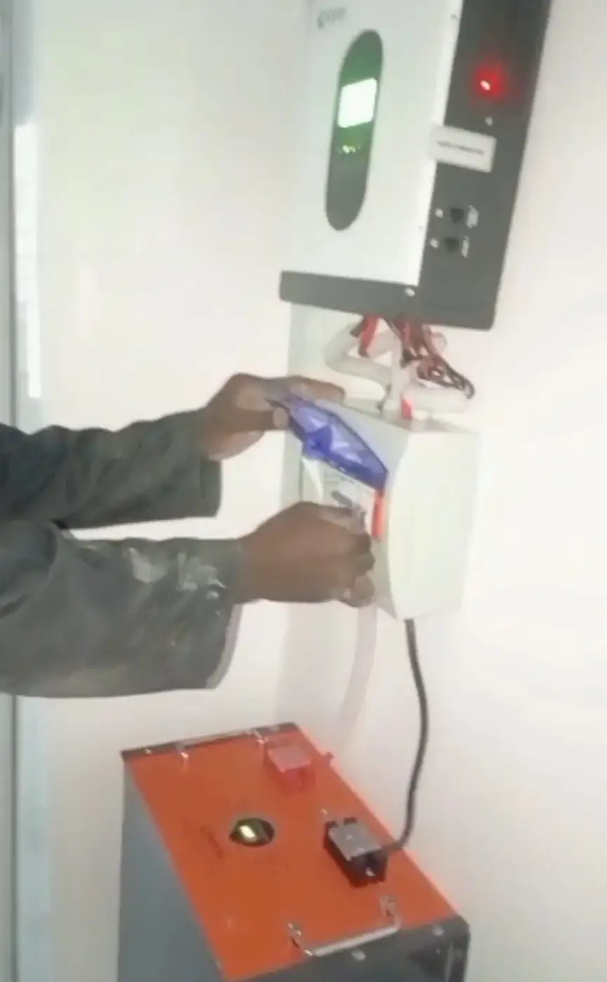 Technician connecting the battery to the breaker