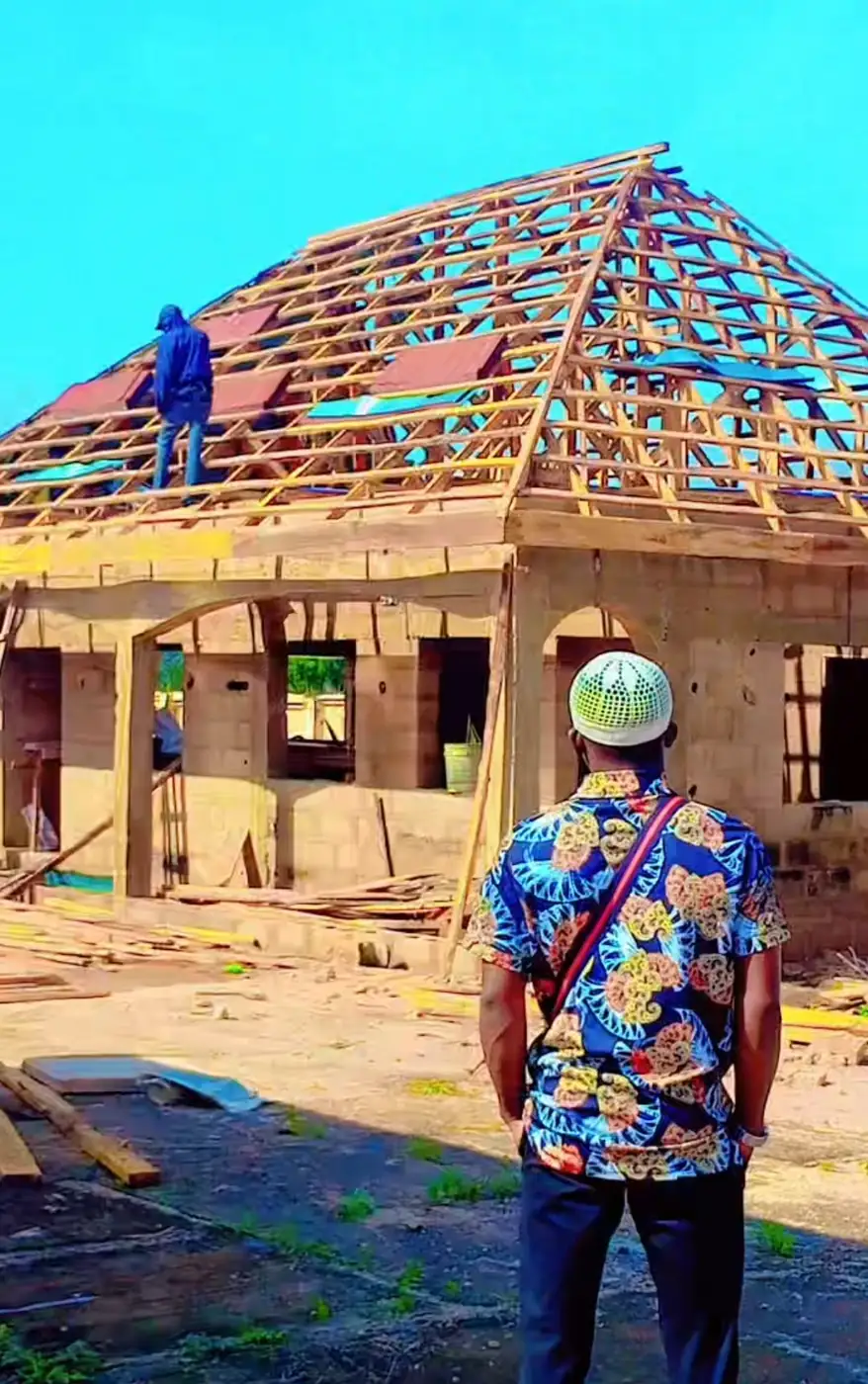 Supervisor checking the roof frame from the ground