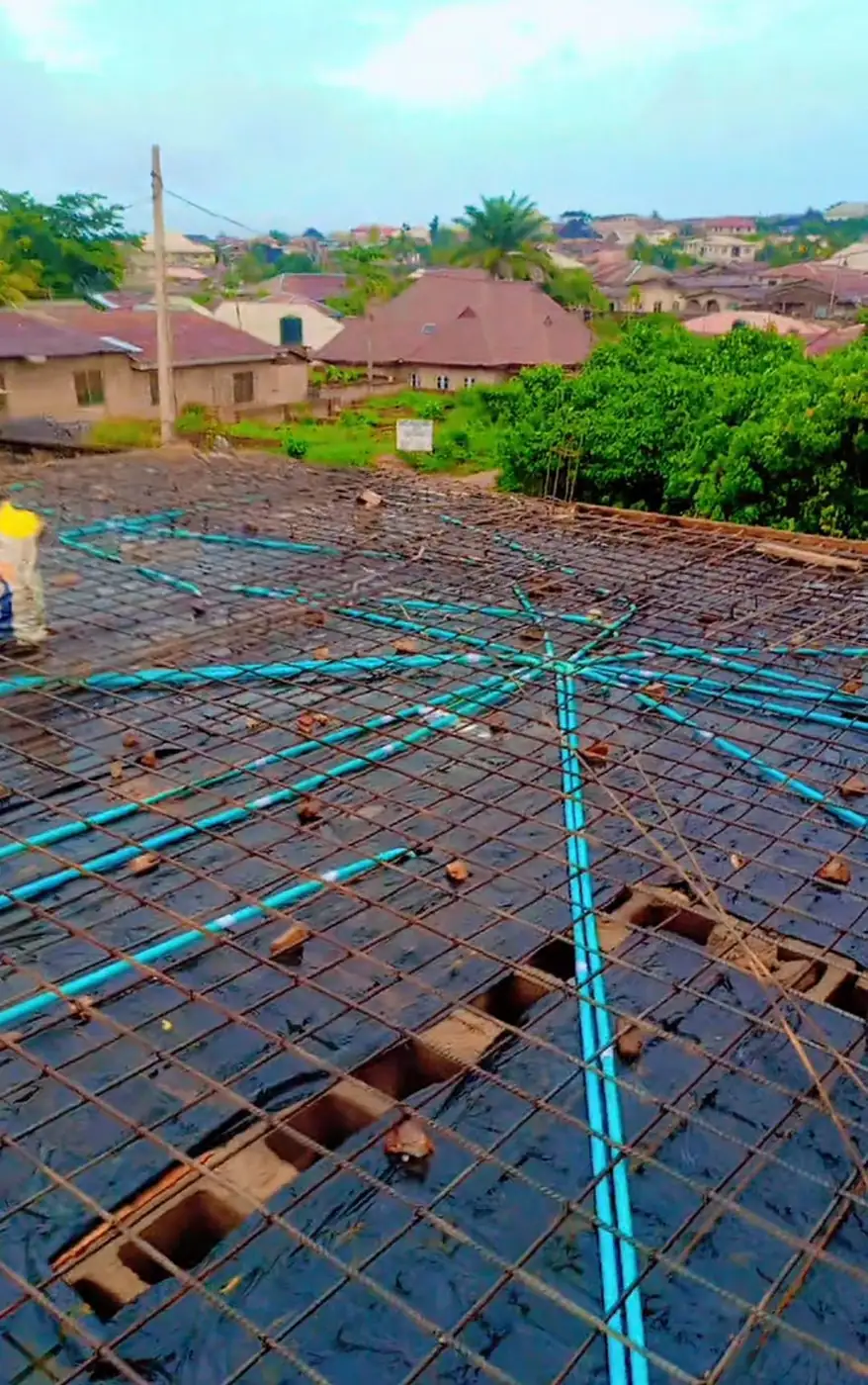 Conduits fanning out from a junction box over slab steel