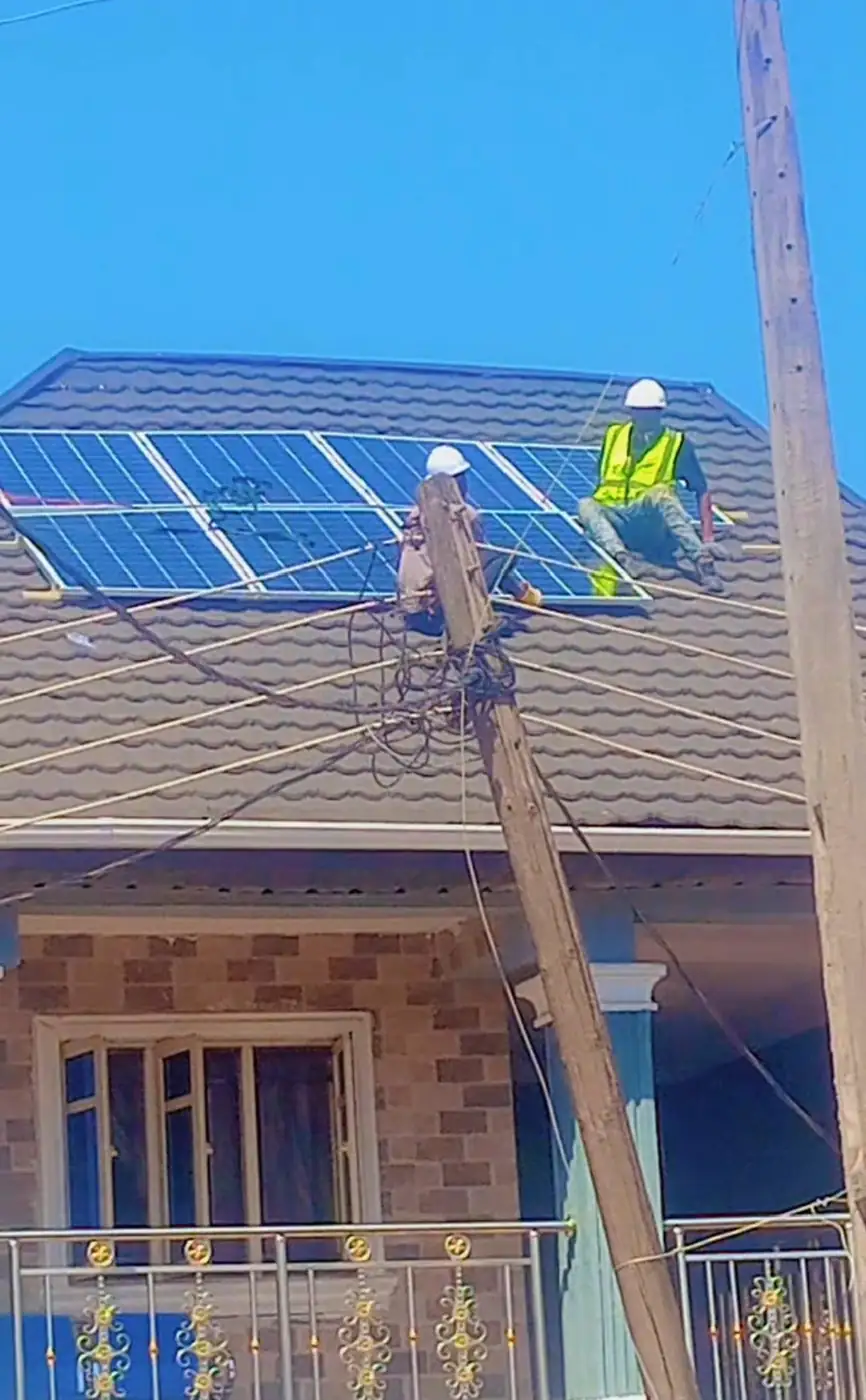 Panels going onto a tiled roof beside the service pole