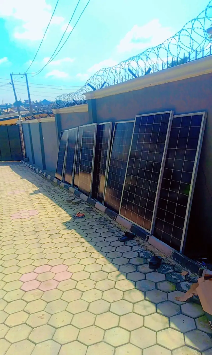 Solar panels staged along a perimeter wall